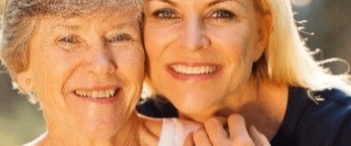 A woman and an older lady smiling for the camera.