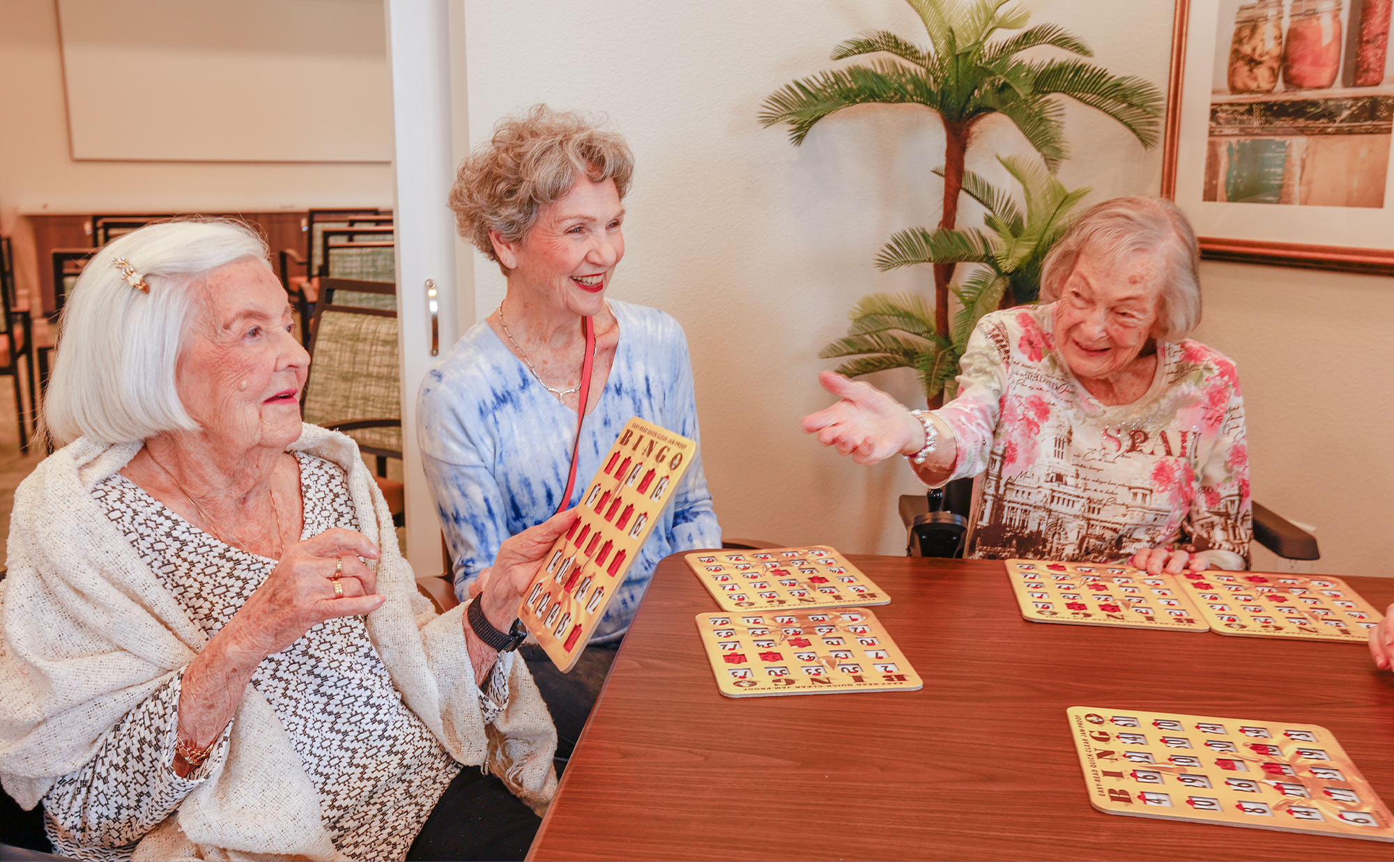 A group of women sitting at a table playing a game.
