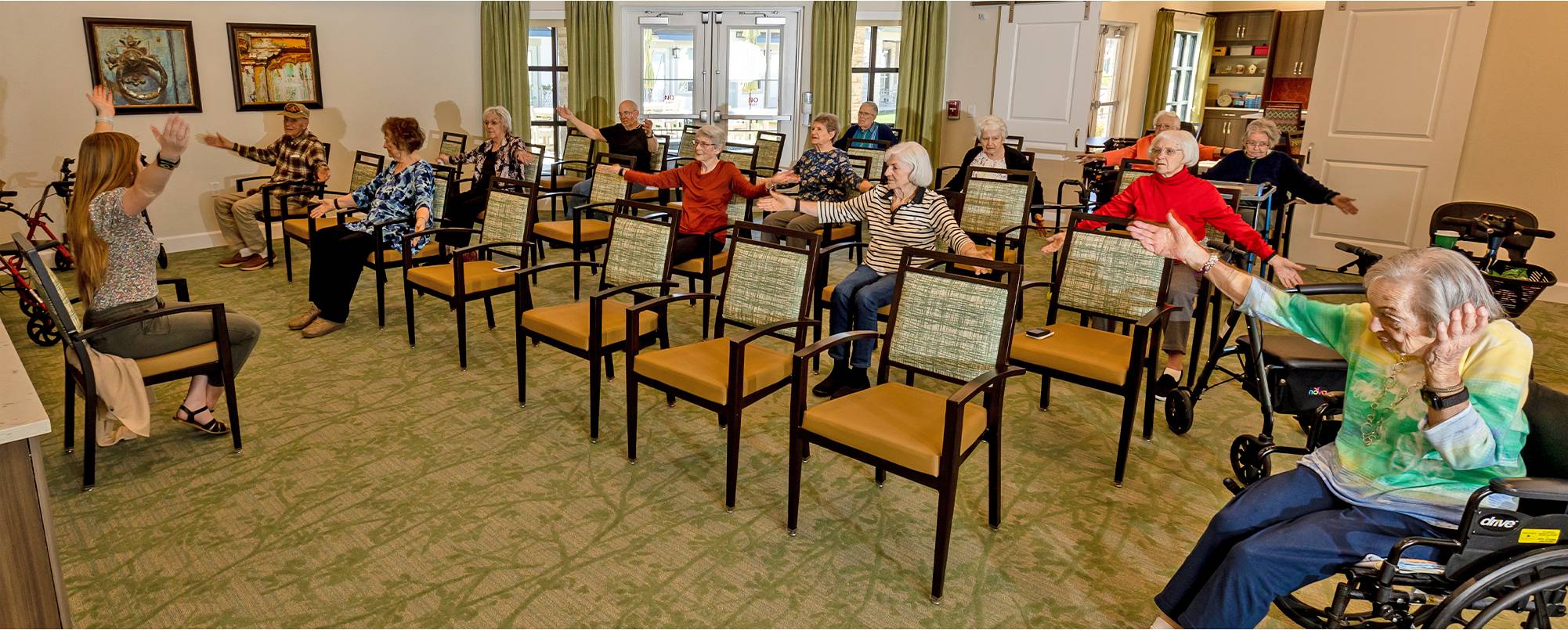 A group of people sitting in chairs with one person standing up.