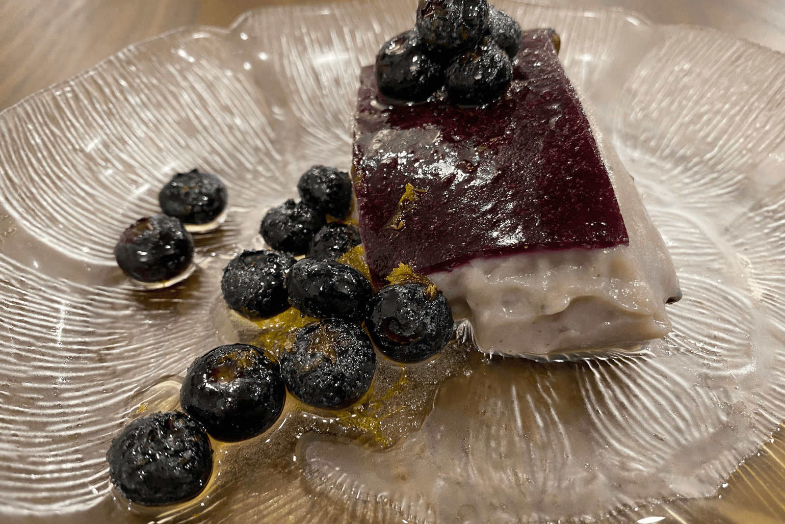 A plate of food with blueberries and lemon.