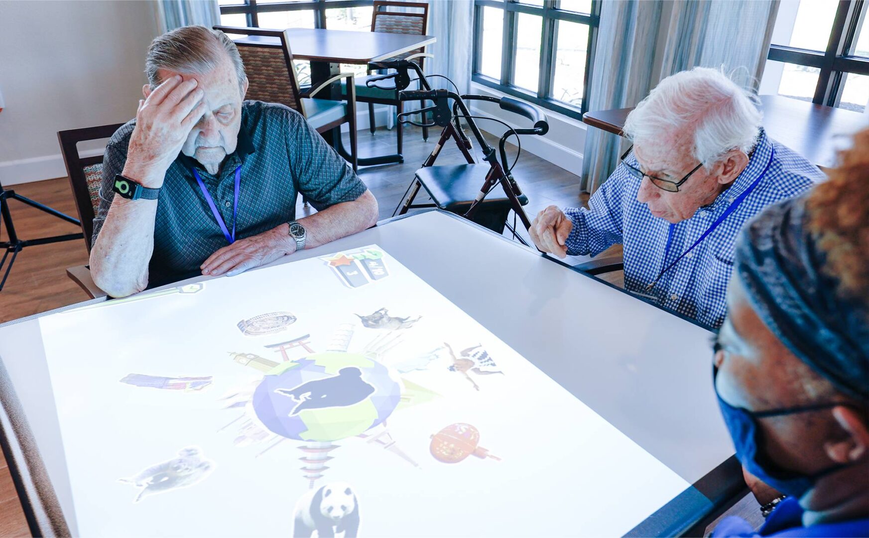 Two older people playing a board game in a room.