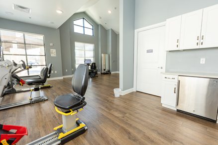 A room with several exercise equipment in it.