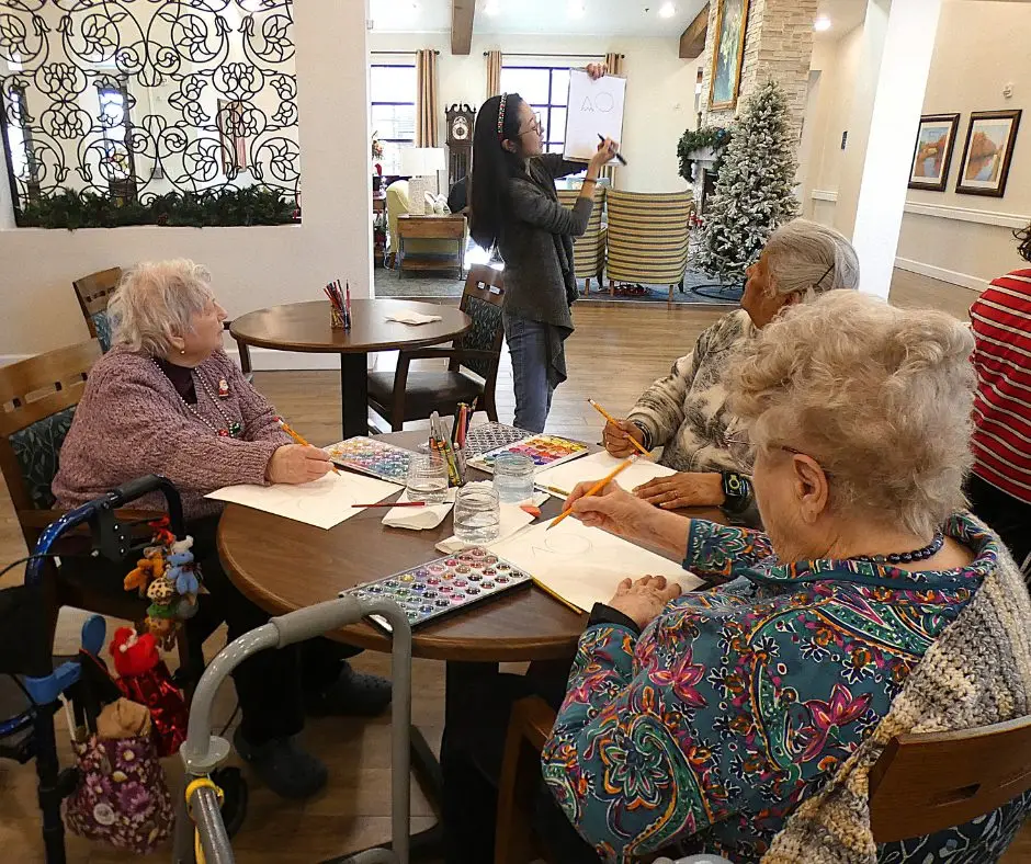 Assisted Living Residents having fun Following Along with Art Teacher