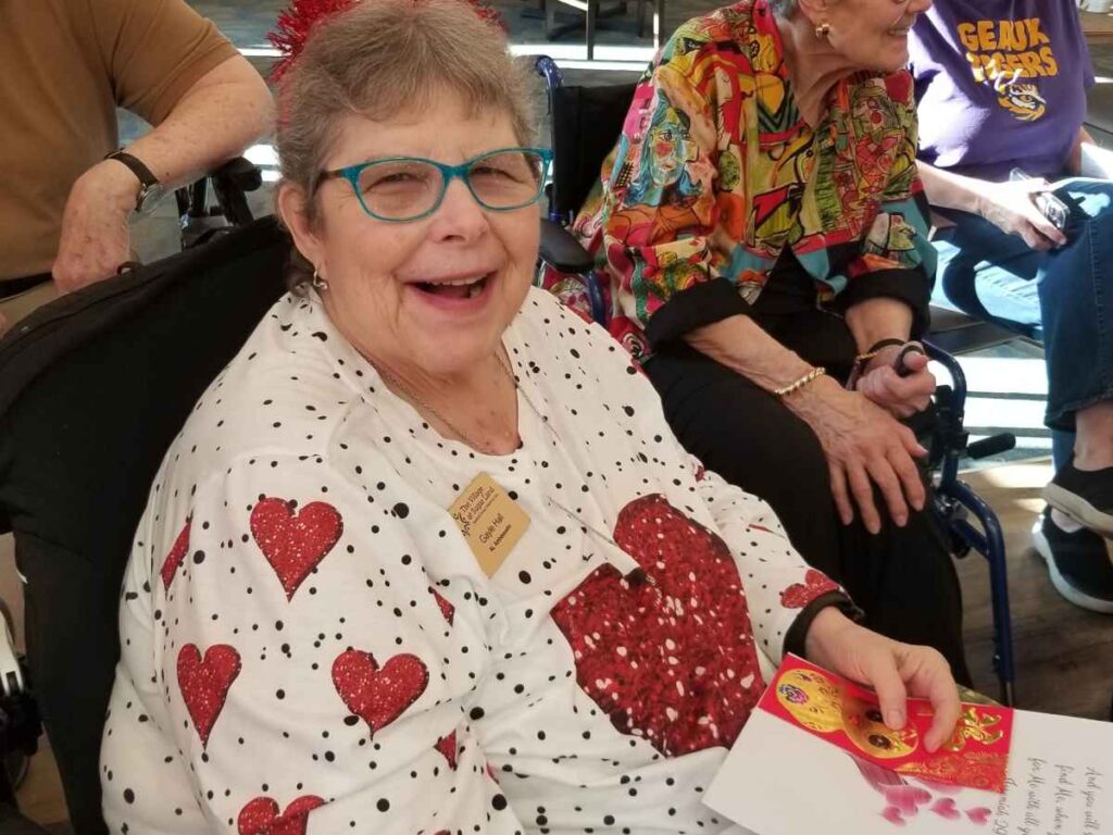 An elderly woman in a memory care community dressed up for Valentine’s Day.