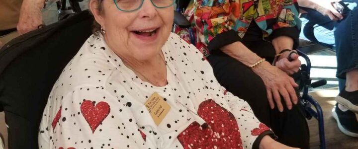 An elderly woman in a memory care community dressed up for Valentine’s Day.