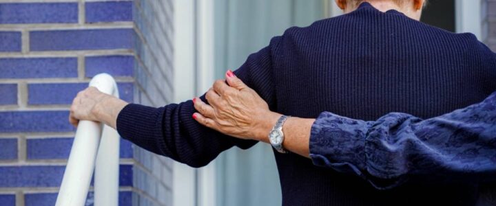 19 Patient Elopement Prevention Strategies Used in Memory Care Units A memory care community team member walking into a building with an eloped patient.