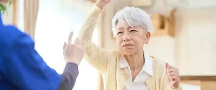 A caregiver fending off a loved one with dementia aggression.