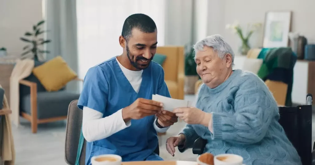 Nurse assistant sharing a photo with a senior woman